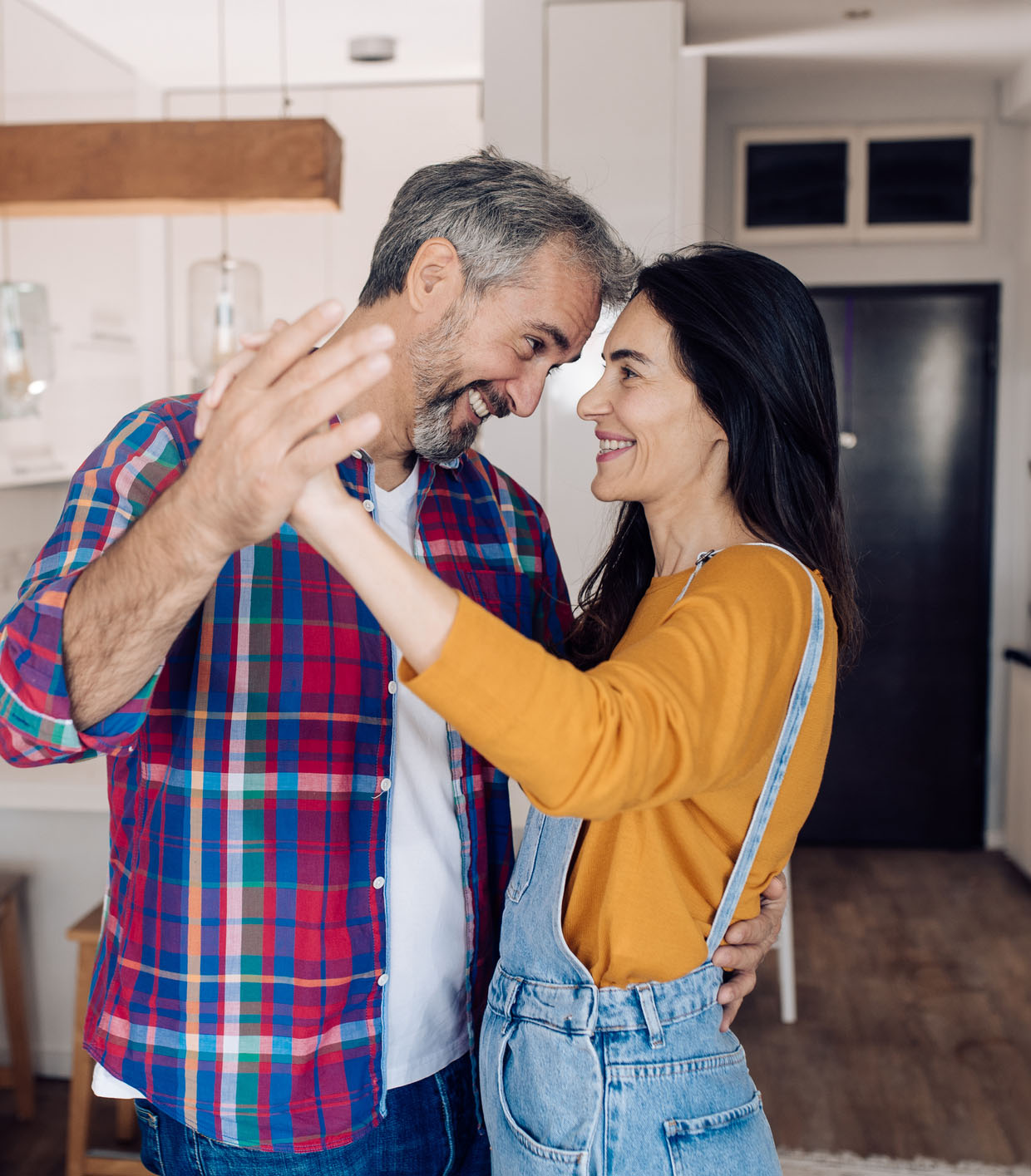 Mature couple in love dancing and enjoying at home