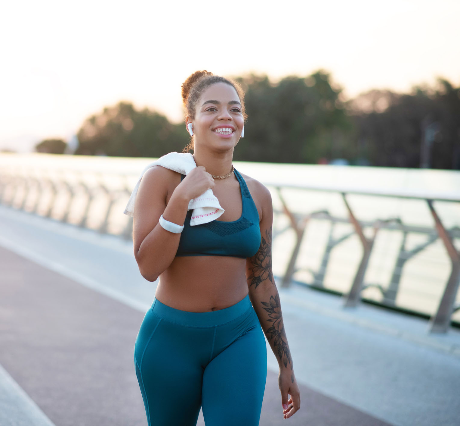 Tattooed young woman going home after running in the morning